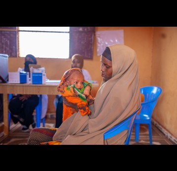 Muslima Ahmed holds her child as she waits for him to receive a dose of vaccine at the outreach vaccination facility in Walaag 1 IDP camp. This is part of the Reach Zero Dose Children (ZDC) campaign in Somalia, aimed at identifying vaccinating children who have not received any vaccines, or missed communities by healthcare systems. Gavi/2024/Mohamed Abdihakim Ali