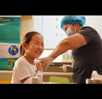 A girl receives the HPV vaccine from a health worker in Mongolia. Credit: Gavi/2024/Khasar Sandag