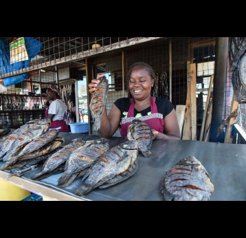 Stella Atieno, displays fish for sale at her stall in Kibuye market, Kisumu, Kenya. The typhoid vaccine has helped her escape the burden of missed work due to typhoid outbreaks.