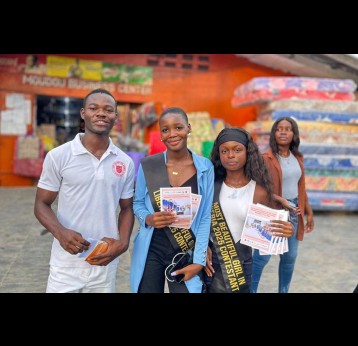 The pageant contestants pause to pose with fans at a local market as they drum up interest in HPV vaccination. Credit: Tina S. Mehnpaine