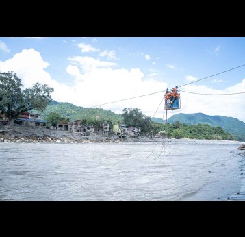 Transporting oral cholera vaccine doses across a fast-flowing river to reach remote communities in rural Nepal. Credit: UNICEF/2026