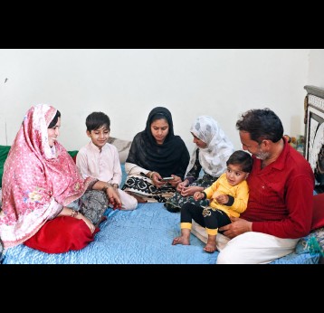 Siraj Ahmed, his wife Humaira, and four of their five children at home. Credit: REEDS, Pakistan
