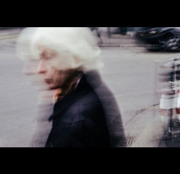 Elderly woman walking in the street. Photo by Mario Heller on Unsplash