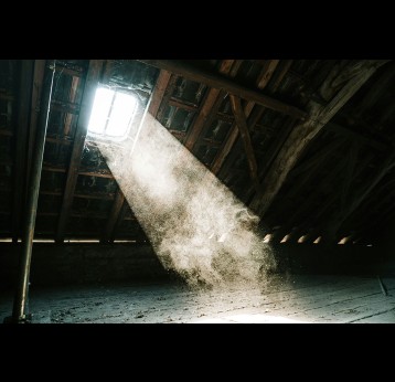 A dusty attic. Photo by Mika Baumeister on Unsplash 