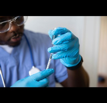 Health worker prepares vaccine injection. Photo by Nappy on Unsplash