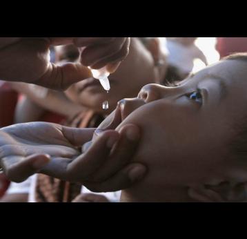 Child receiving an oral vaccine dose