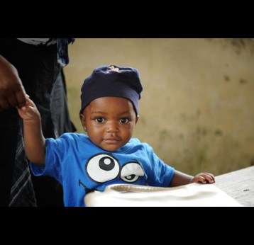 A child waits at a medical centre in Douala, Cameroon. Photo: Sanofi Pasteur.