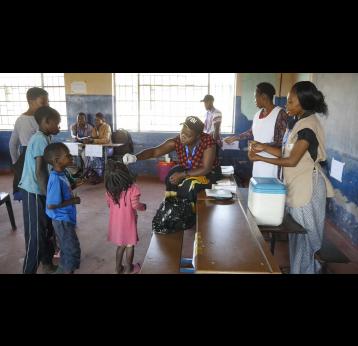 Child receiving an oral cholera vaccine dose