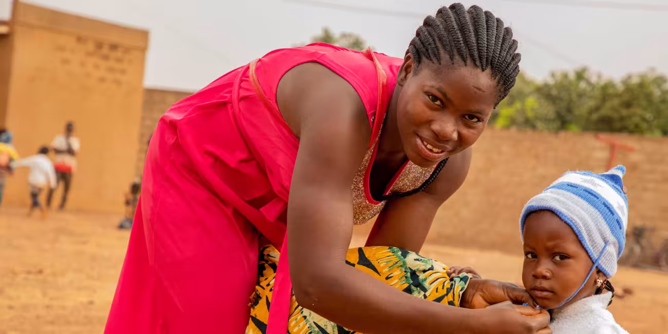 A mother and her child in Burkina Faso during a malaria vaccination session. Credit: Gavi/2024/Arnauld Yalgwueogo