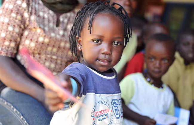 A child holding a vaccine card in Rwanda. Credit: Gavi/2010/Riccardo Gangale