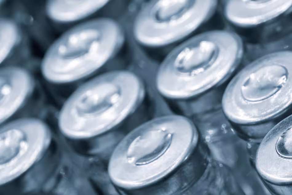 Glass vaccine vials on production line machine conveyor