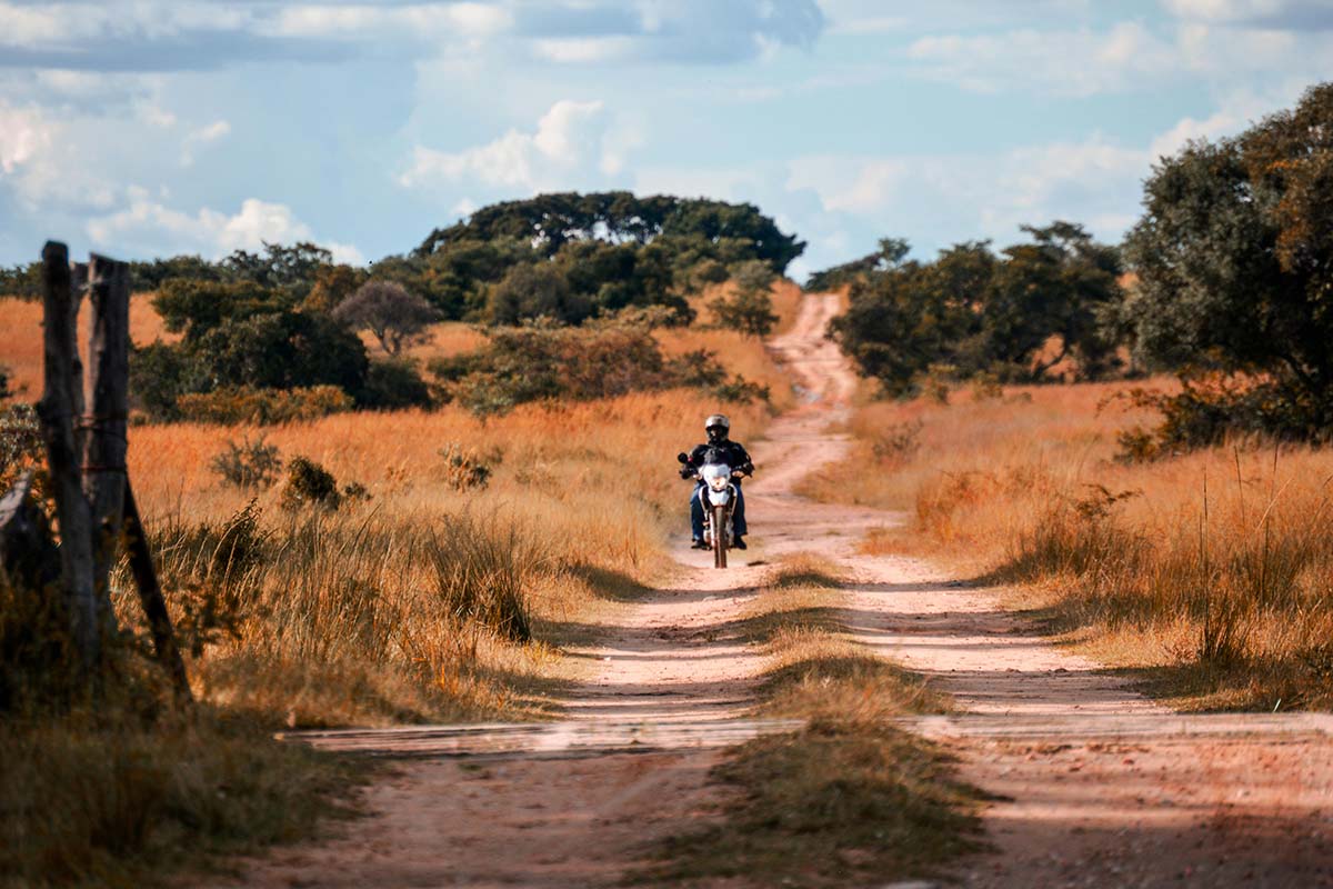 Man drives on dirt road through rural Zimbabwe. Credit: Jhune Bleu on Pexels