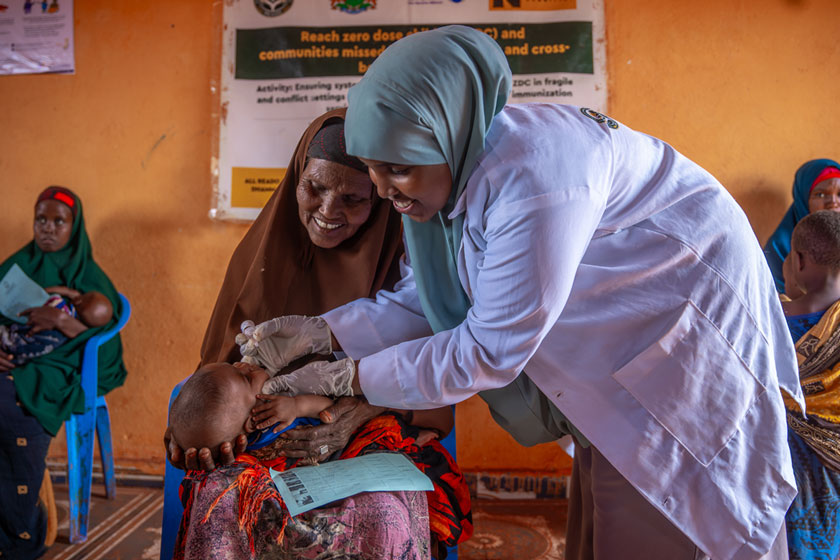 Nurse administers an oral vaccine to a child, held by his grandmother in Southwest State, Somalia. Credit: Mohamed ​Abdihakim ​Ali 