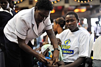 Mary Wambui looks on as a nurse delivers the first of three pneumococcal vaccine doses to her daughter Esther Nyambura in February 2011.