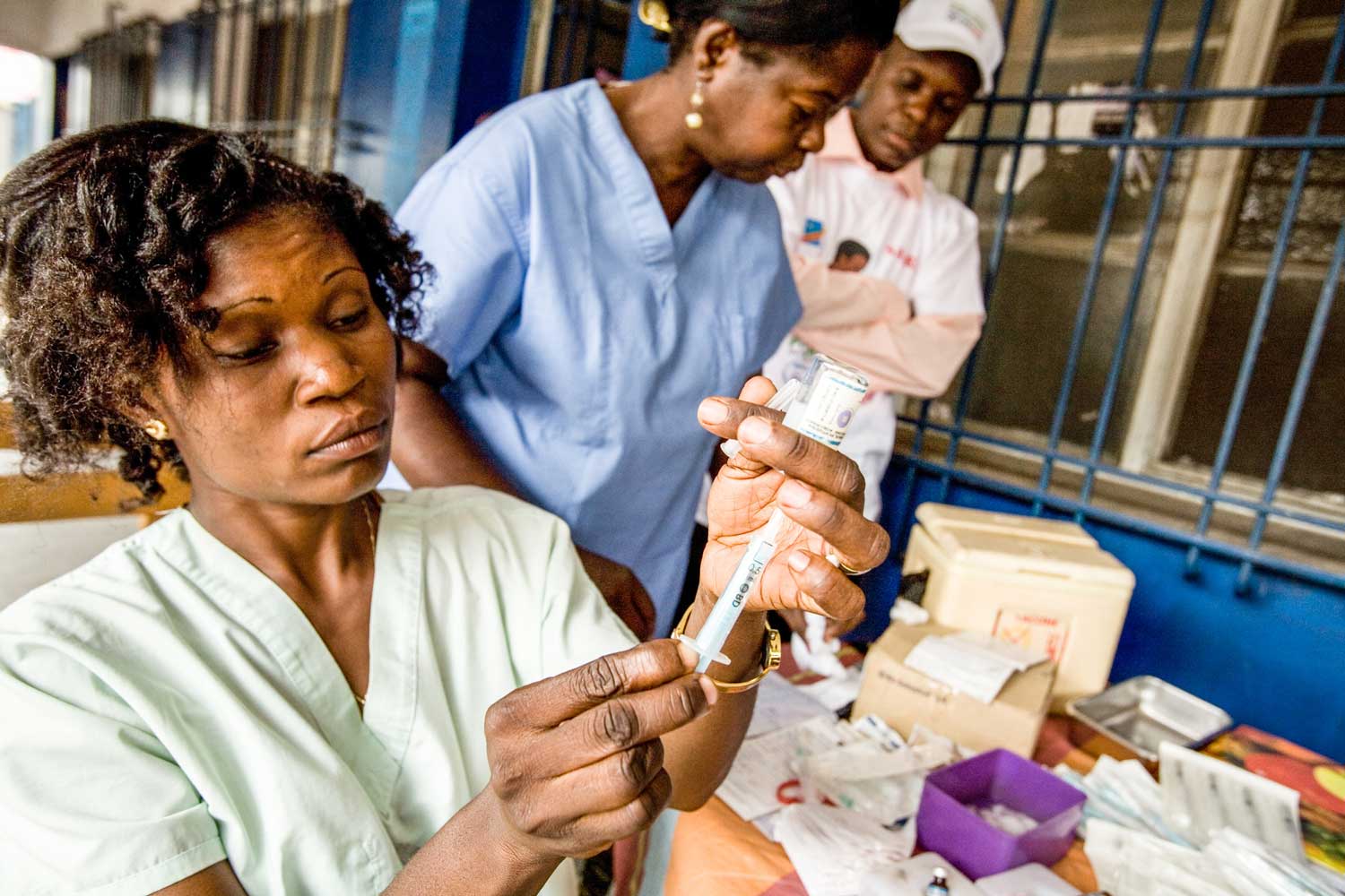 A female health worker prepares a vaccine