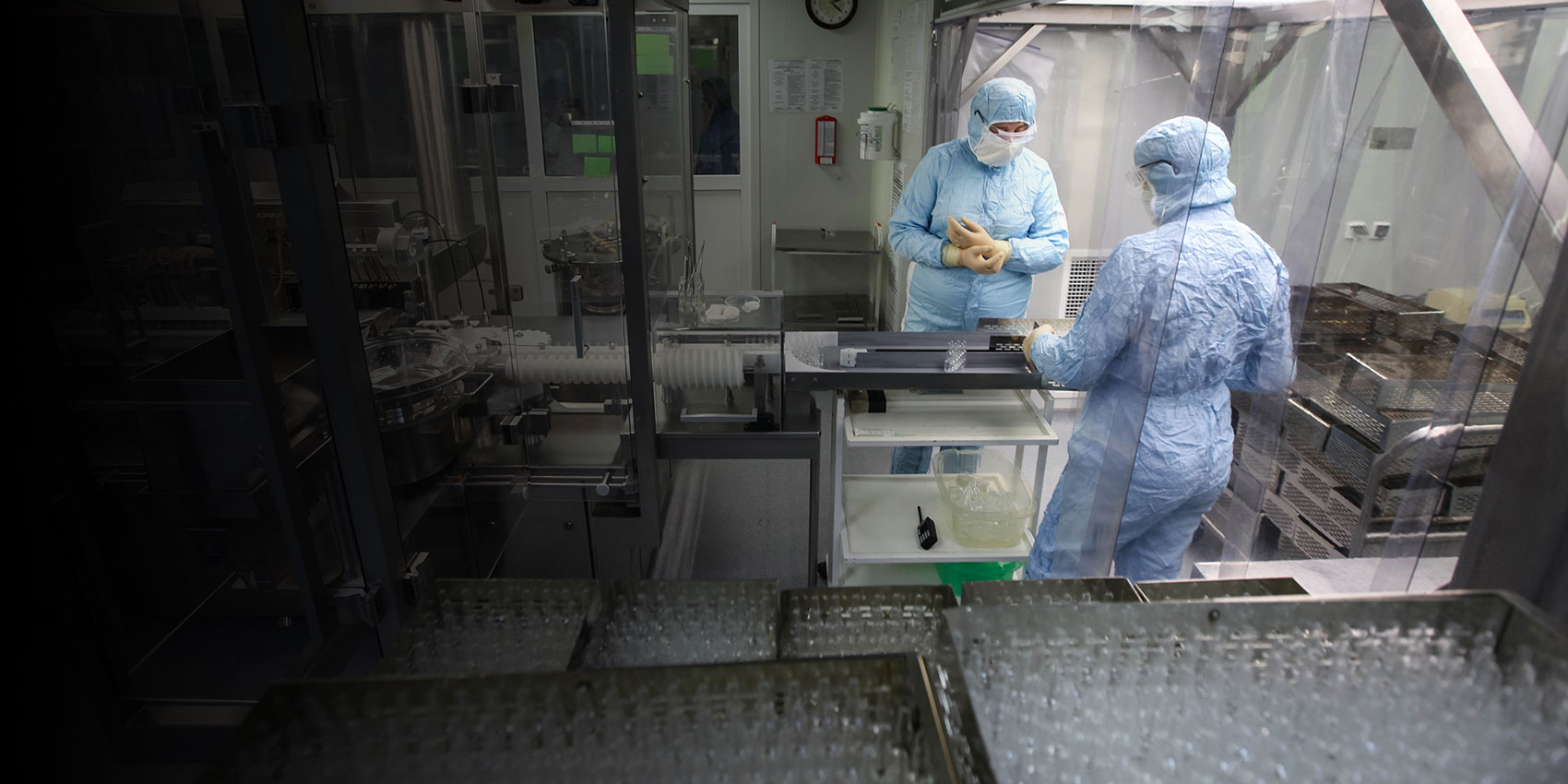 Lab technicians wearing personal protective equipment for vaccine manufacturing. Credit Gavi