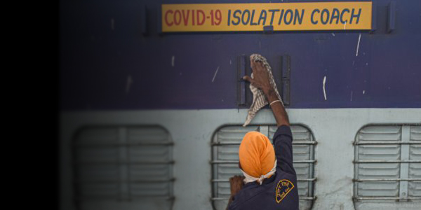 Credit: Biplov Bhuyan/Hindustan Times via Getty Images – A worker cleans the exterior of a train coach that has been converted into a Covid-19 isolation ward in New Delhi, India. Healthcare systems have had to rapidly adapt infection control practices to isolate coronavirus patients.