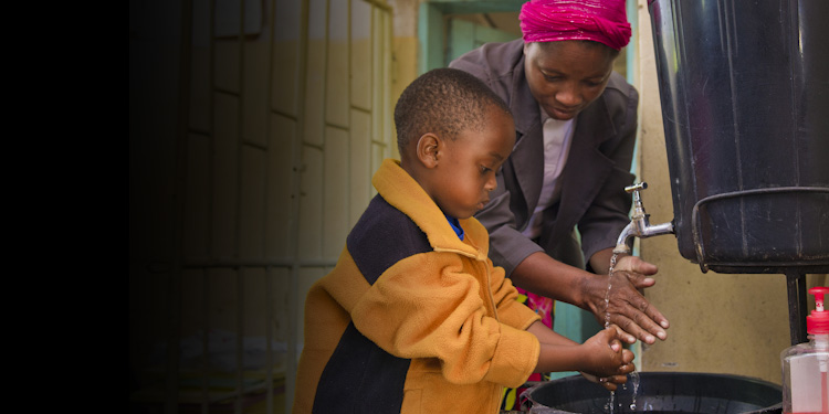 Boy washes his hands at a health clinic in Zambia. PATH/Gareth Bentley