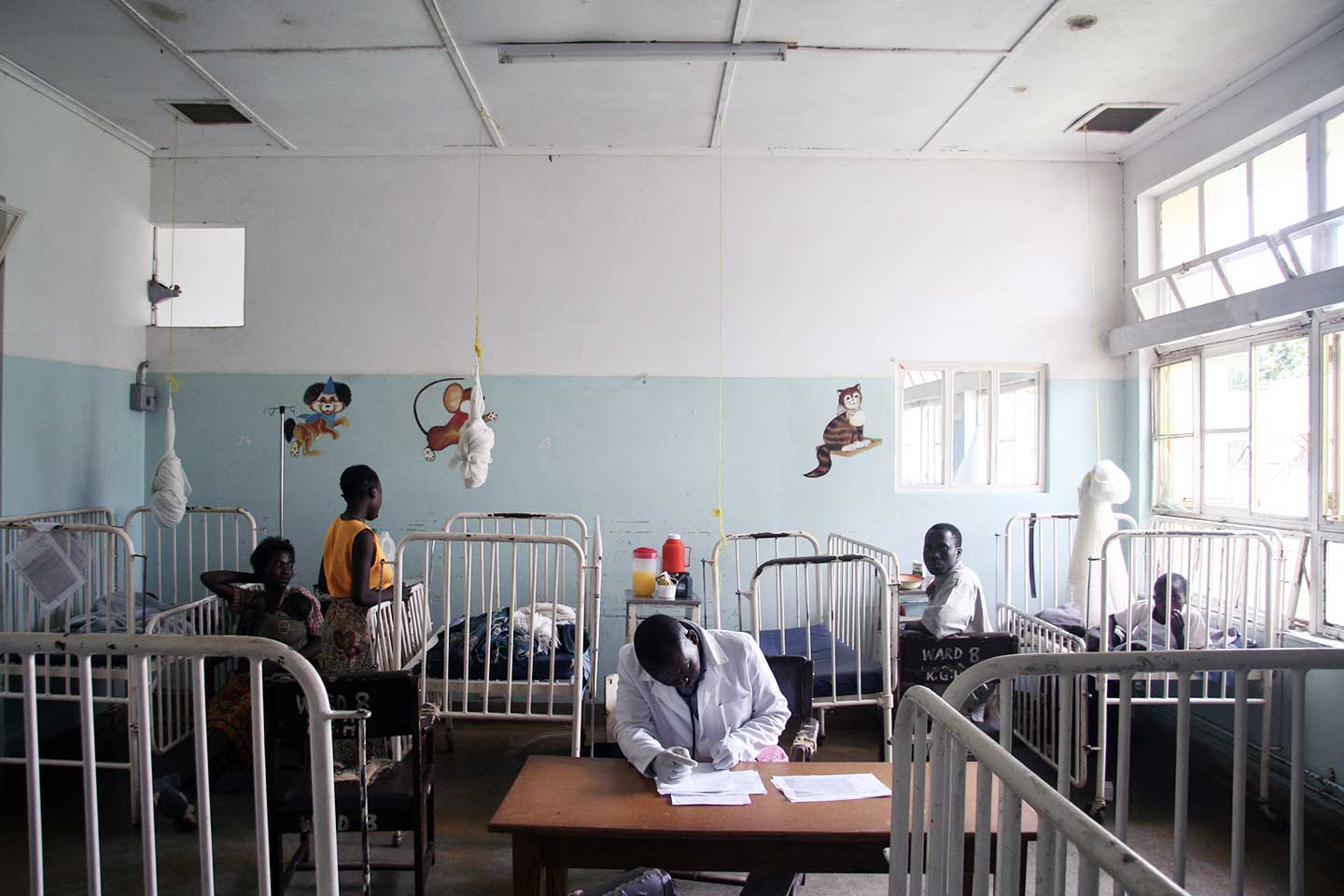 Photo: A health worker sits at a desk in a pediatric hospital room in Zambia. When children fall ill with diarrheal disease, the hospital bills can add up – and the indirect costs, too. PATH/David Jacobs
