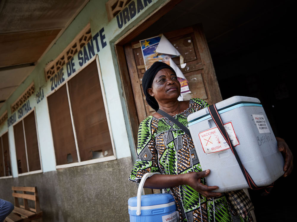 Health worker Apuma Matungulu visits villages in Bandundu on foot with her cooler box of polio vaccines to vaccinate children. © Hugh Cunningham