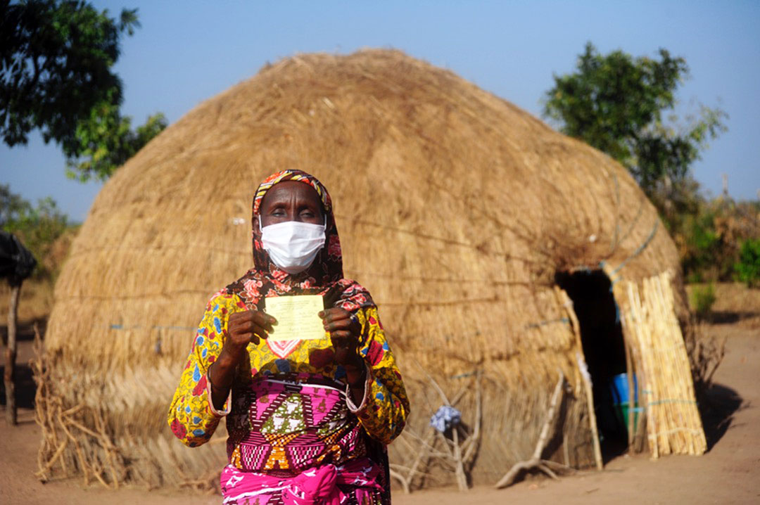 A woman in the Fulani settlement in Daboya in the Savannah Region of Ghana shows off her yellow fever card. ©UNICEF/BUTA