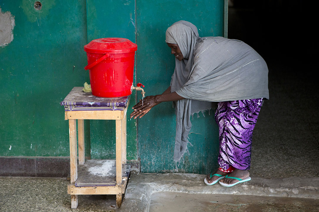 A woman washes her hands outside the cholera treatment centre in Banadir hospital in Mogadishu, Somalia. – Photo: Gavi / Karel Prinsloo