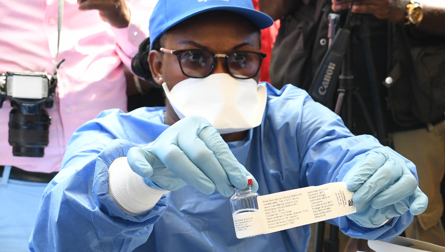 Protected health worker displays Ebola vaccine, DR Congo – Gavi/2018/Pascal Barollier Protected health worker displays Ebola vaccine, DR Congo – Gavi/2018/Pascal Barollier
