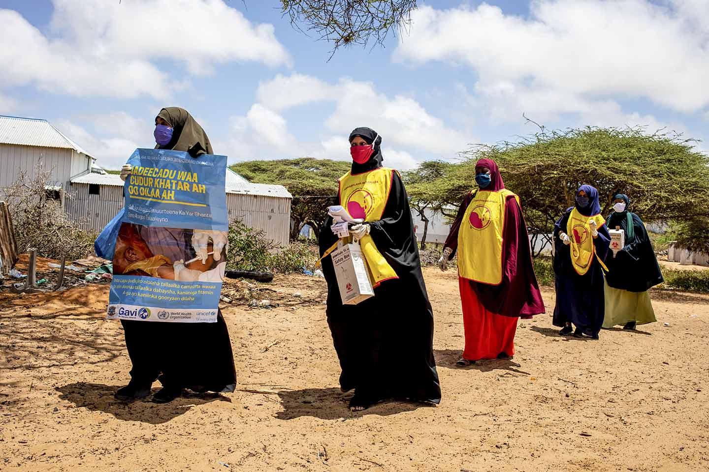 Health workers walk to at Kahda district as they wait for children to vaccinations as part of national polio and measles vaccination campaign in Mogadishu, Somalia on Tuesday 01 September 2020. Photo Ismail Taxta / Ildoog/WHO SOMALIA