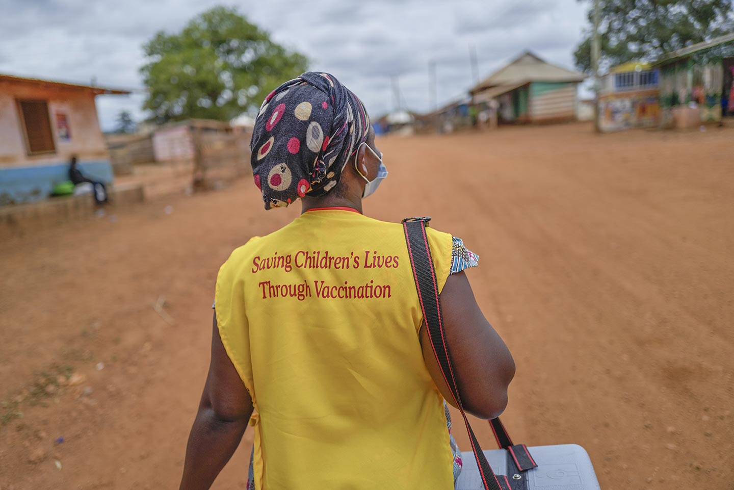 A volunteer walks through the Kotokuom community in the Ashanti Region to reach children who have not yet received the polio vaccine on 11 September 2020. ©UNICEF/ACQUAH