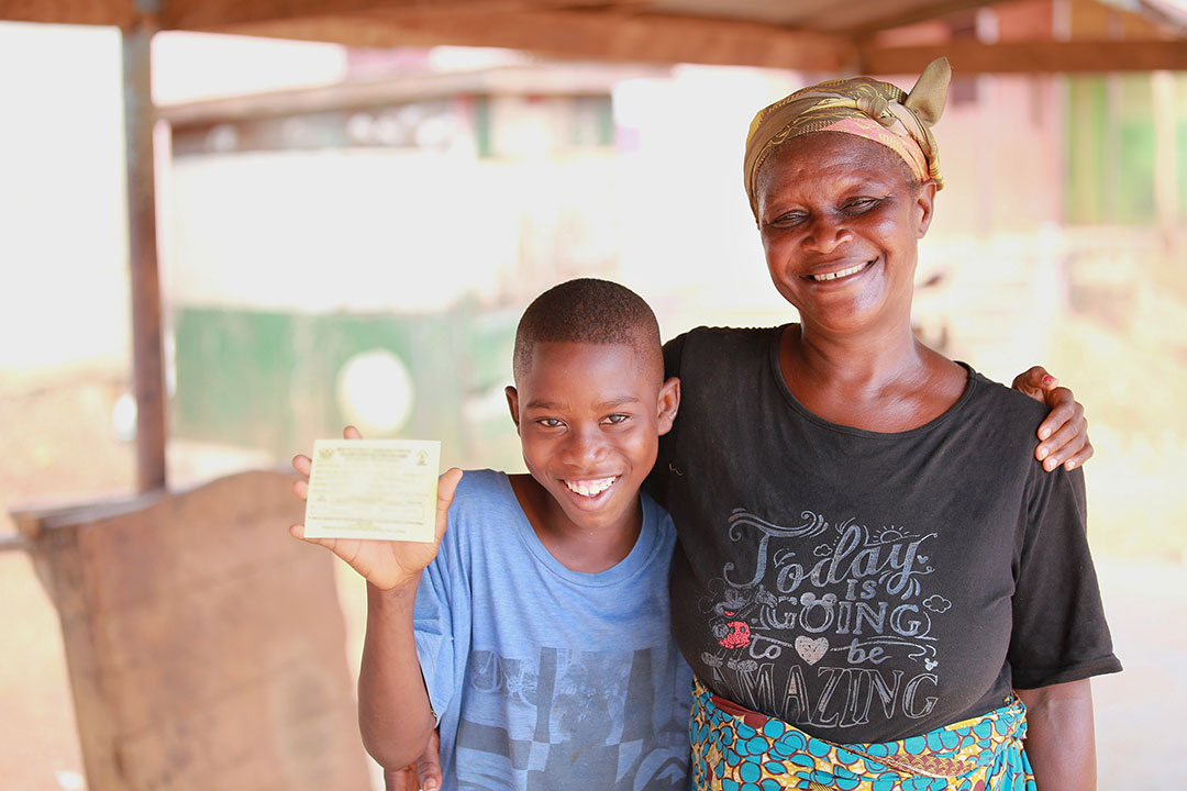 Justice shows his yellow fever vaccination card. His grandmother came with him so he could be vaccinated against yellow fever. ©UNICEF/MILLS