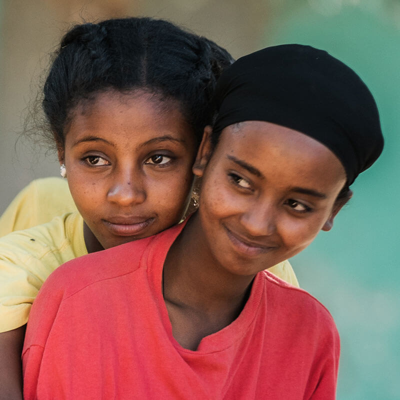 Beza and her friend sharing a hug