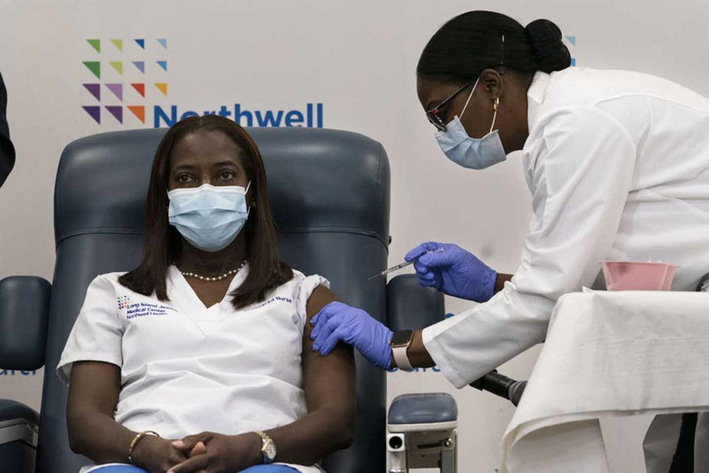Sandra Lindsay, a nurse at Long Island Jewish Medical Center, is given the COVID-19 vaccine – she is one of the first in the US to receive it. EPA/Mark Lennihan