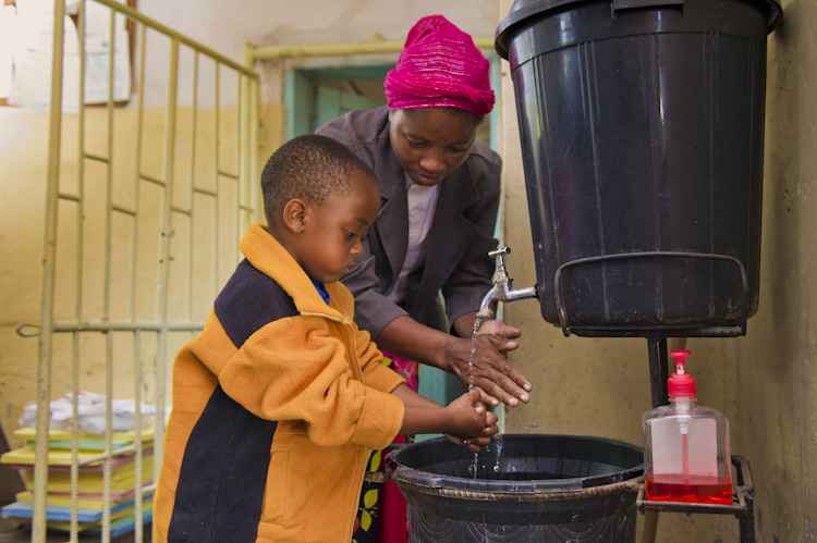 Boy washes his hands at a health clinic in Zambia. PATH/Gareth Bentley
