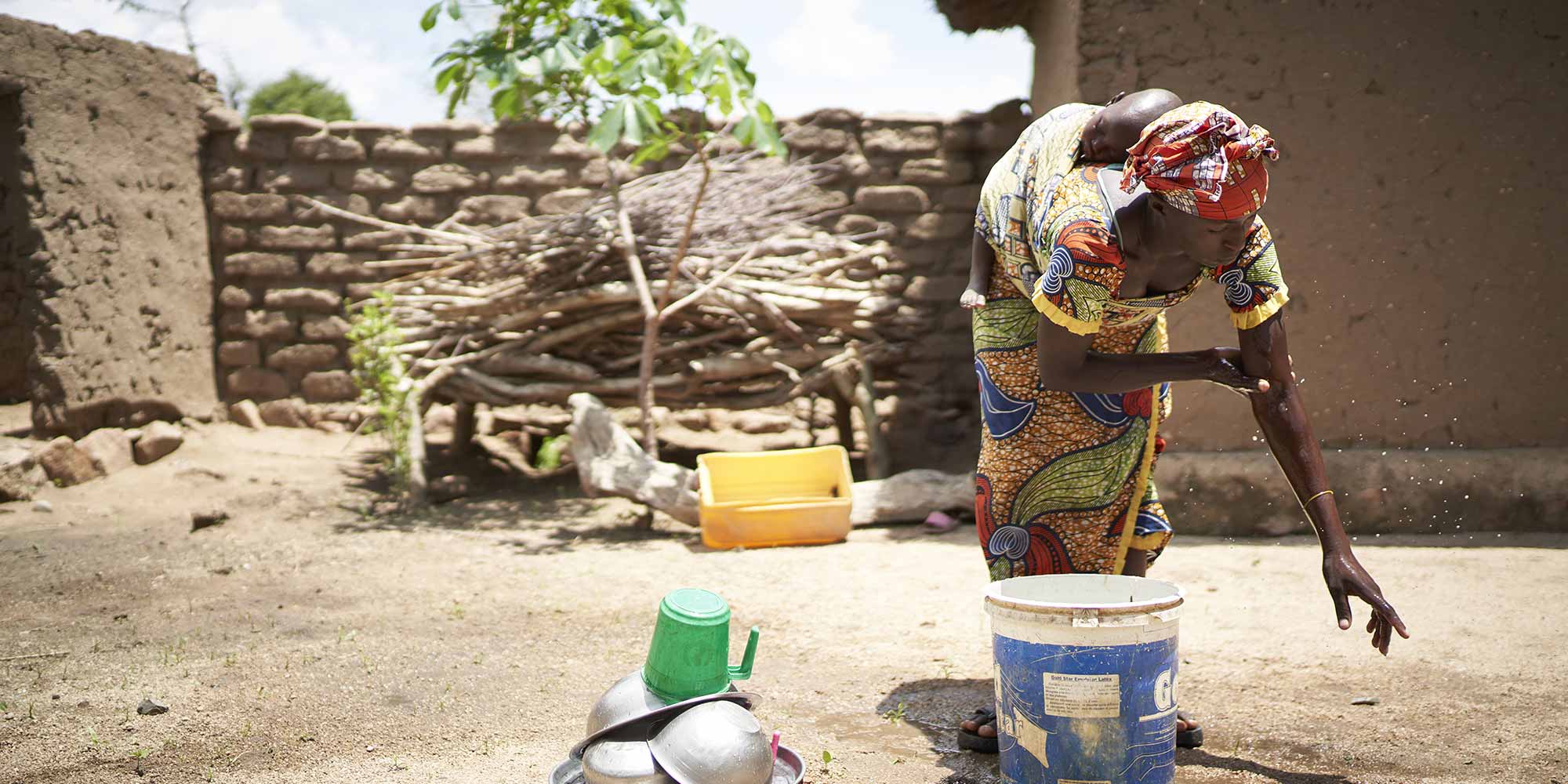A woman washing her hands at a handwashing station in front of her home in Marua, Cameroon. Credit: Gavi/2020/Christophe Da Silva