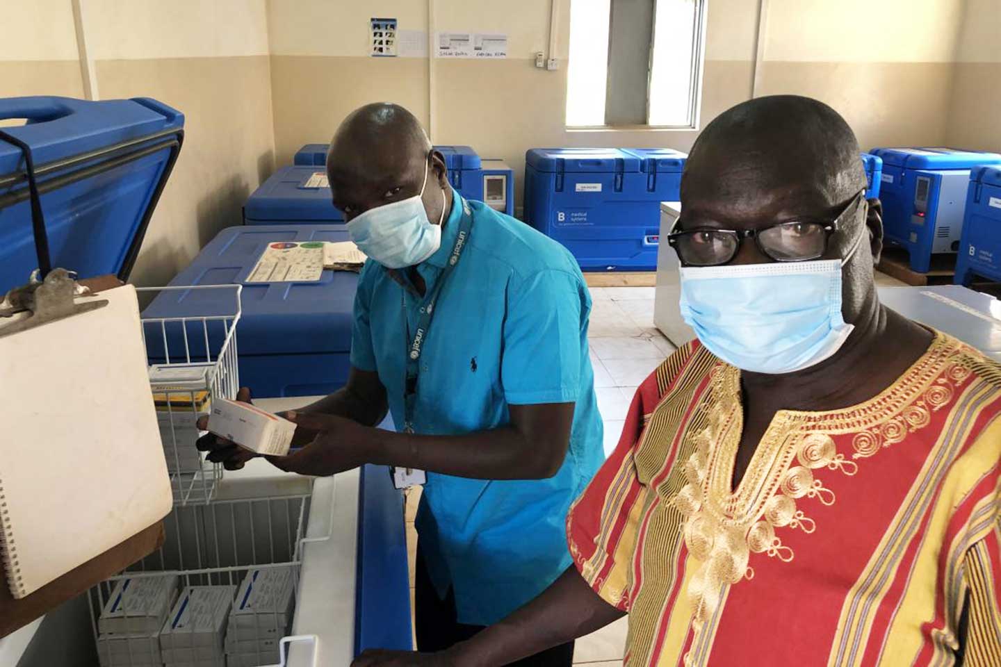 @ UNICEFSouthSudan/Willemot Evans Ariko Shawish (right) Manager, Expanded Programme for Immunization, Ministry of Health, Western Equatoria State and Daniel Drinchi, Health Officer, UNICEF Yambio field office, inspecting the central cold chain storage in the state capital Yambio. The cold chain is now used for measles and polio vaccines among others and will soon also be used for COVID-19 vaccines.