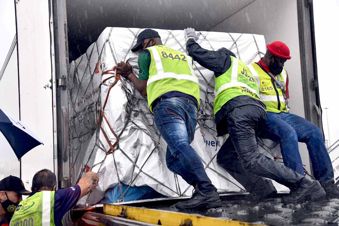 Workers load South Africa’s first Covid-19 vaccine doses at OR Tambo airport in Johannesburg on Feb. 1.