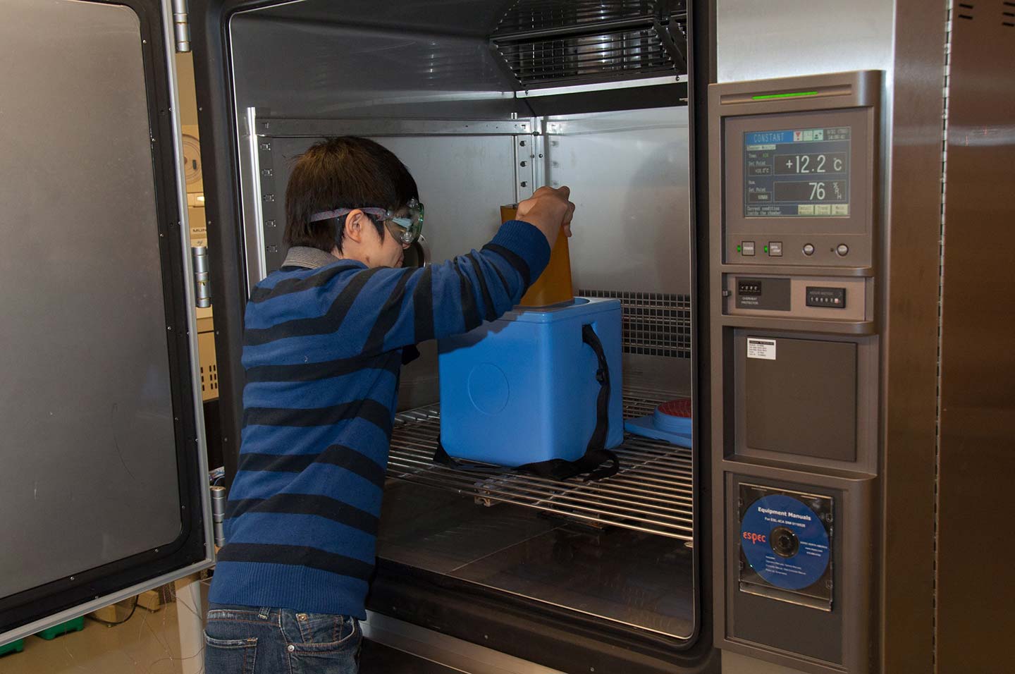 A PATH staffer prepares to test a vaccine carrier in an environmental chamber in our product development shop (photo taken pre-pandemic). Seattle, Washington. Photo: PATH/Patrick McKern.