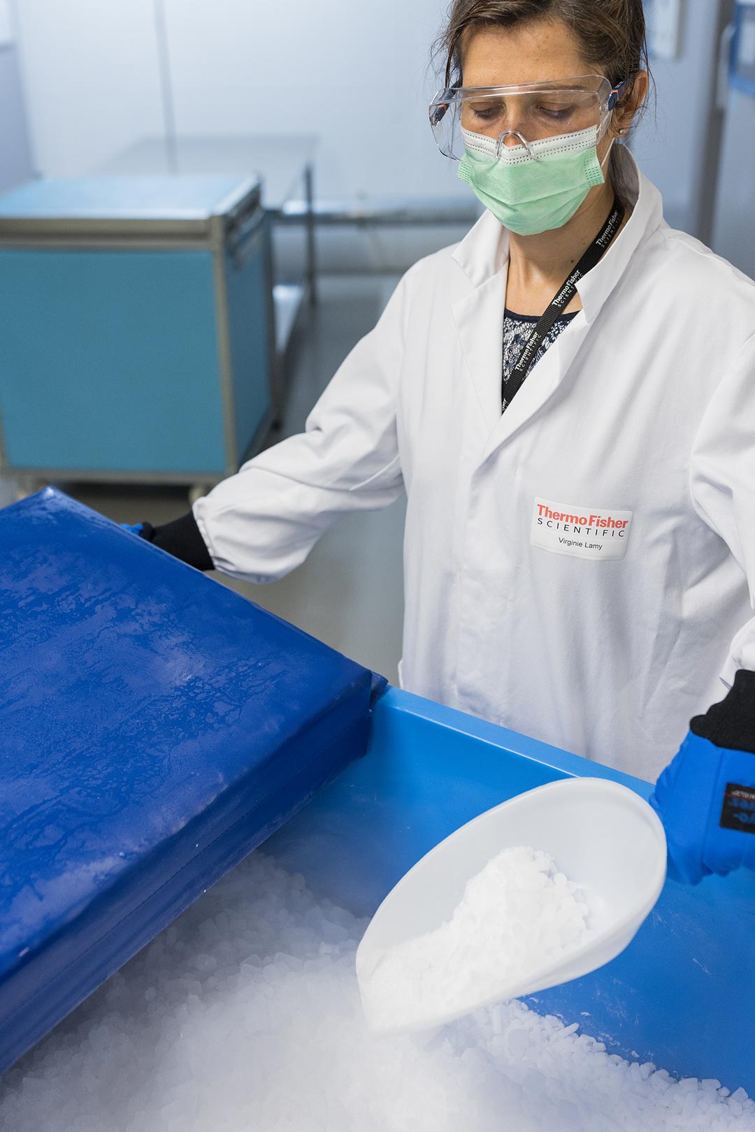 The Ebola vaccine must be kept at between -60 and -80°C, well below what normal vaccine freezers are capable of. Virginie explains how dry ice, or frozen carbon dioxide, is used as a cooling agent to keep the vaccines at the right temperature during storage and transport. She is wearing protective gloves to prevent burns and injury caused by freezing.