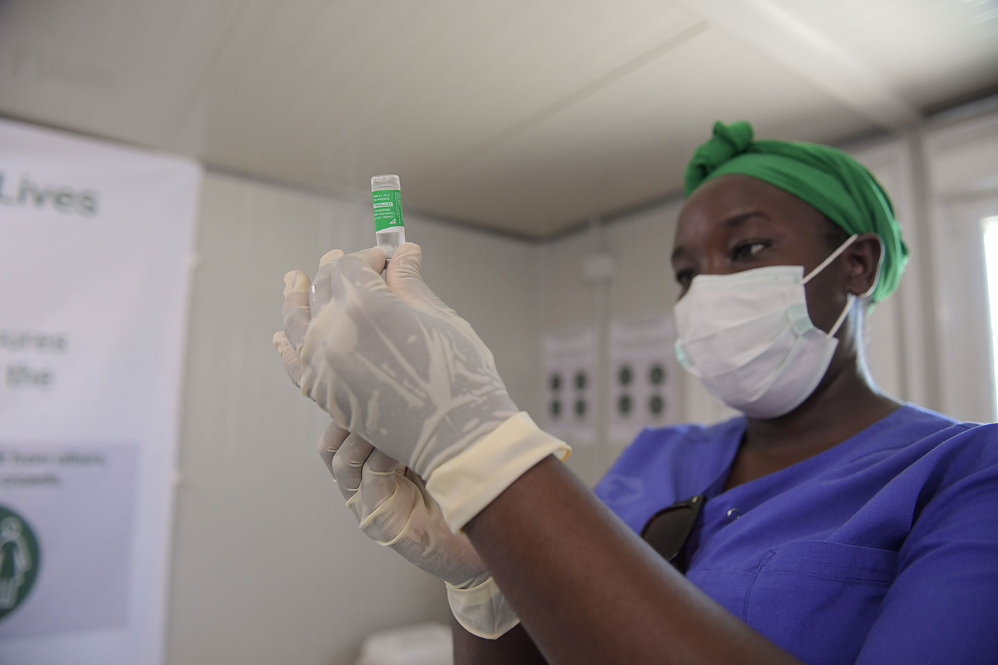 A medical officer prepares to administer the COVID-19 vaccine. Copyright: AMISOM Photo/Mokhtar Mohamed, Public Domain