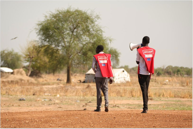A Medair mobiliser walks within Mingkaman, spreading messages about when and where the local population can receive cholera vaccine. By Diana Gorter