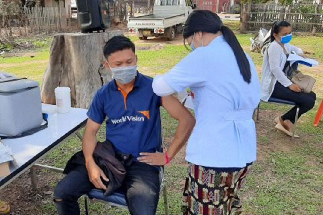 A citizen of a remote area in Laos gets his COVID-19 vaccine