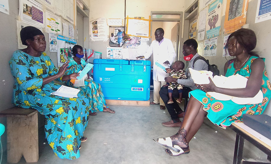 A health worker explains vaccination to a mother