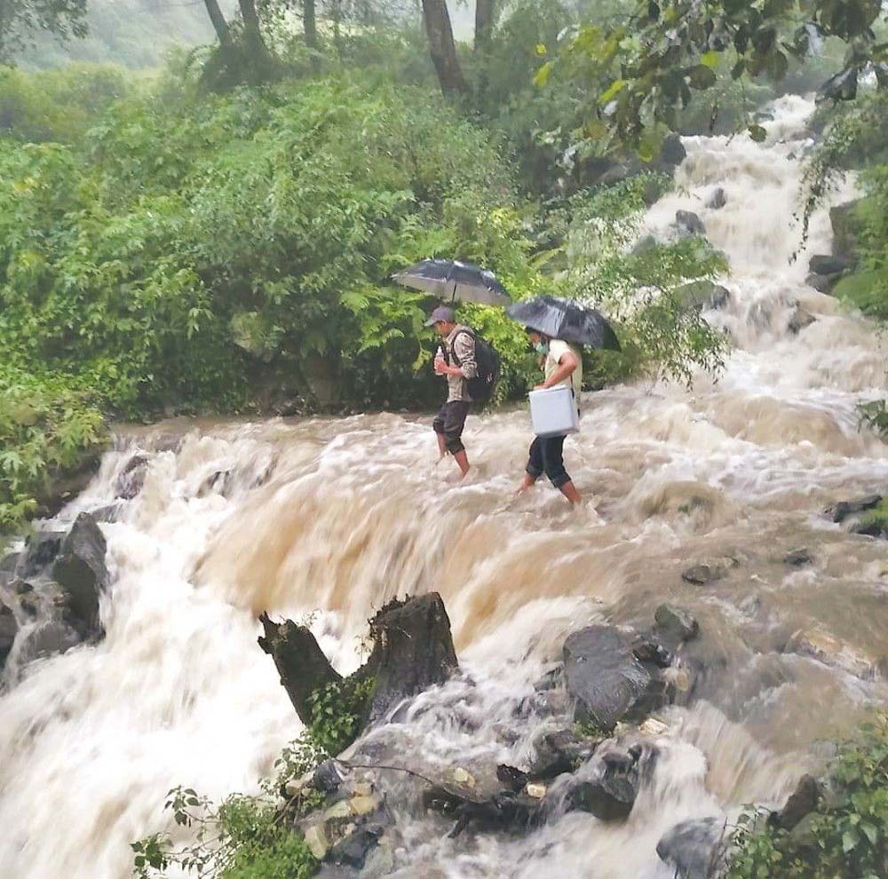 Health workers brave harsh terrain to get COVID-19 vaccines to the Nepalese population