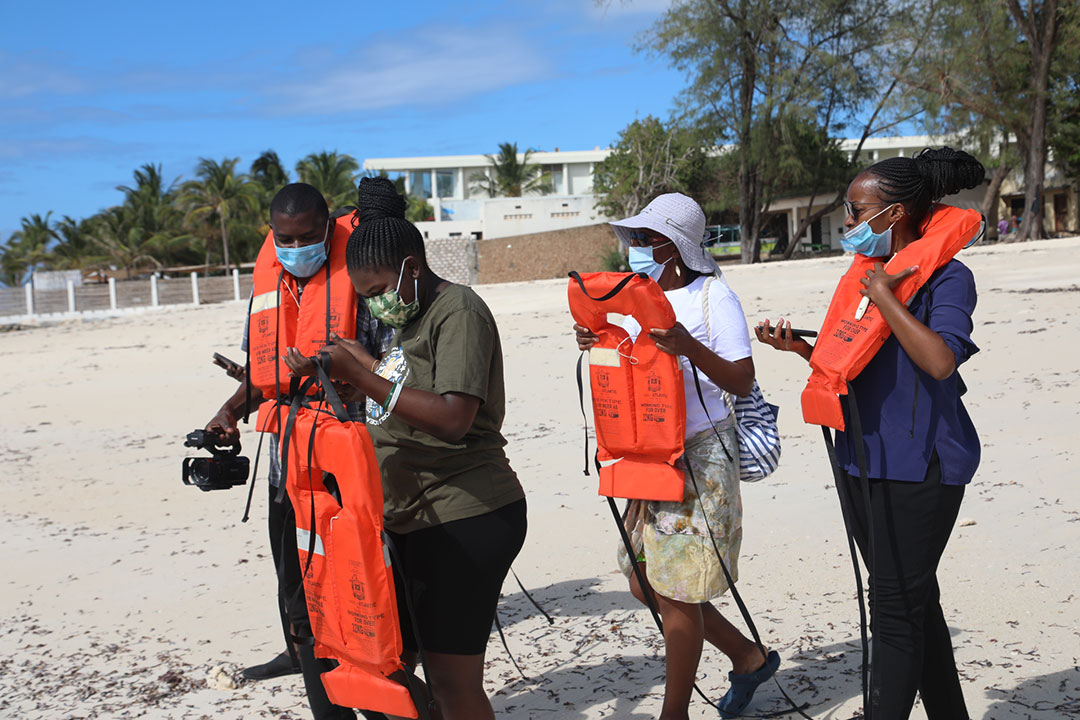 Vaccinated and masked tourists walking towards Malindi marine park in Kilifi County