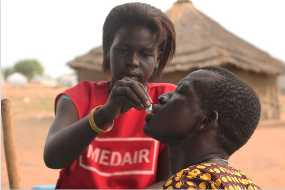 A MEDAIR vaccinator gives cholera vaccine to a man in Mingkaman, South Sudan by Diana Gorter