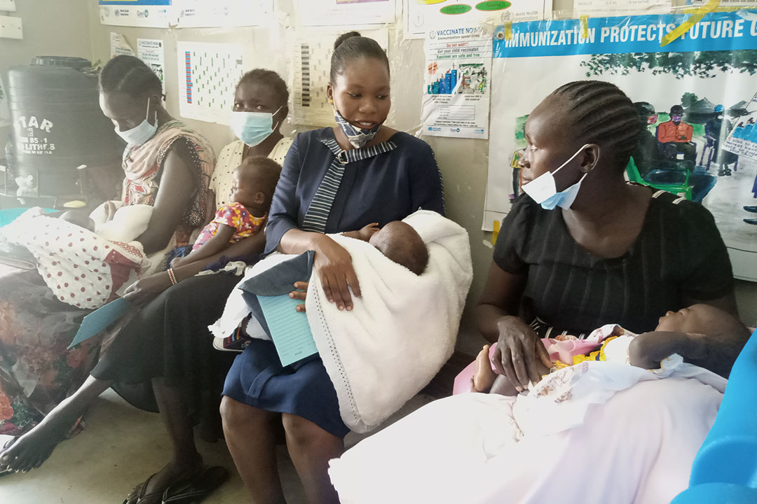 Mothers queue at Munuki Health Center to vaccinate their children