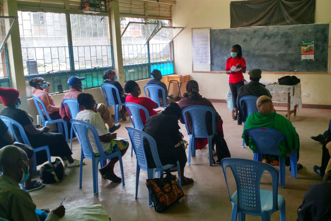 Mrs Immaculate atieno, a community volunteeer engaging other volunteers and monitors during outreach planning meeting in Biafra slum, Nairobi Kenya – Credit: Abjata Khalif