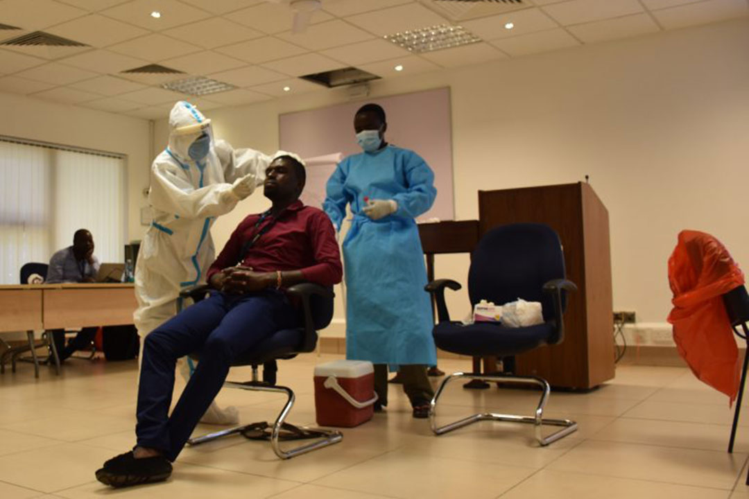 PCVIS staff conducting training for COVID-19 nasopharyngeal sample collection.