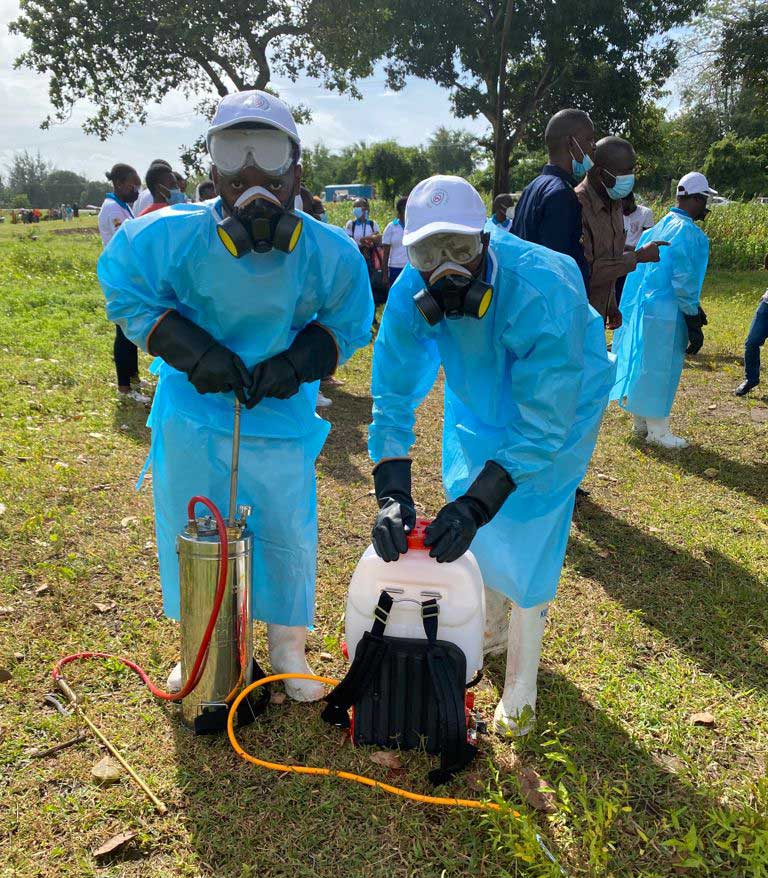 Kazungu Charo (left) prepares for a malaria vector control exercise in Kilifi county. Photo by Kazungu Charo