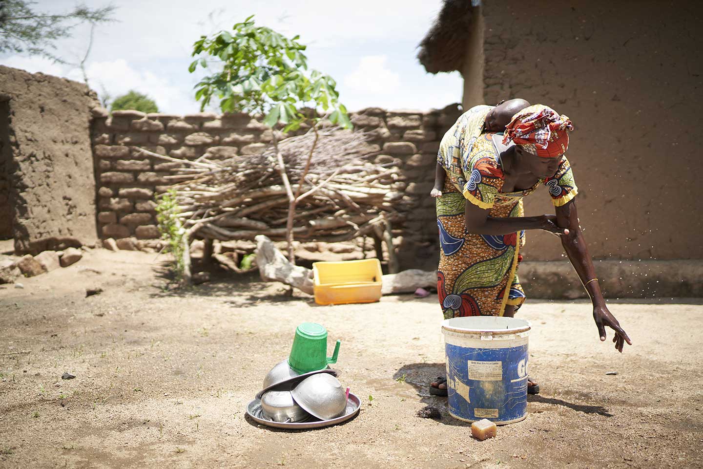 A woman washing her hands at a handwashing station in front of her home in Marua – Photographer credit: Gavi/2020/Christophe Da Silva